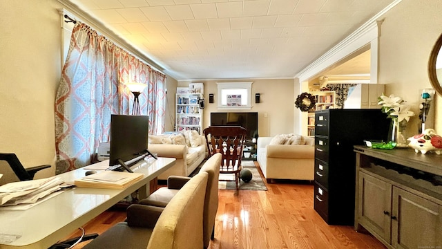 interior space featuring ornamental molding and light wood-style flooring