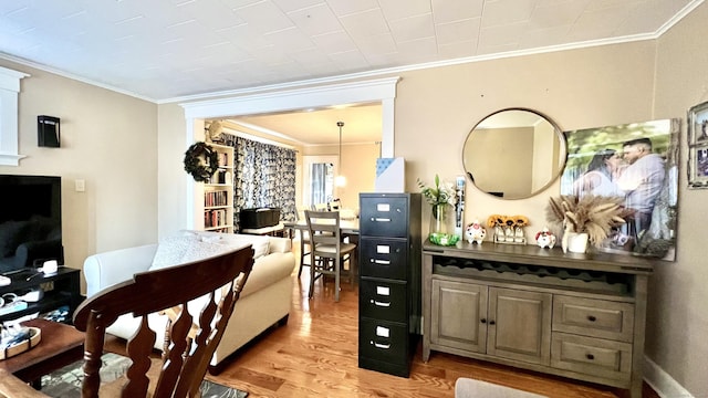 interior space featuring light wood-type flooring and crown molding