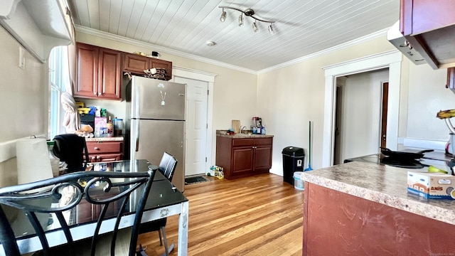 kitchen featuring wooden ceiling, light countertops, ornamental molding, light wood-type flooring, and freestanding refrigerator