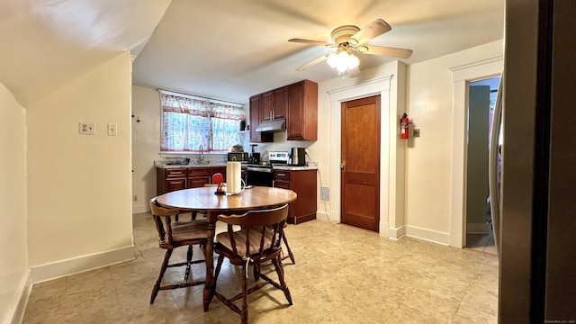 dining room featuring ceiling fan and baseboards