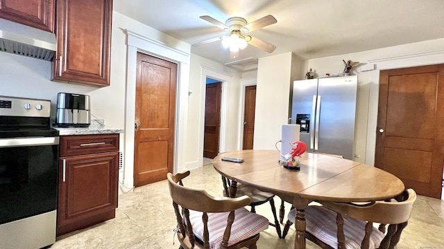 kitchen featuring ceiling fan, appliances with stainless steel finishes, light stone counters, and under cabinet range hood