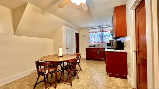 dining area featuring light floors, a ceiling fan, and baseboards