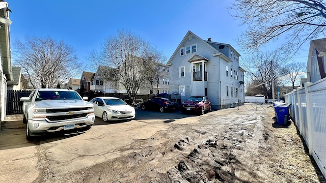 exterior space featuring uncovered parking and fence