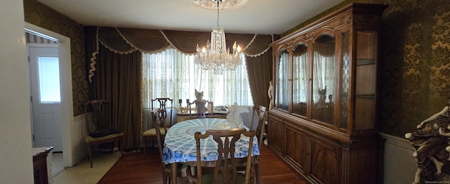 dining space with an inviting chandelier and wood finished floors