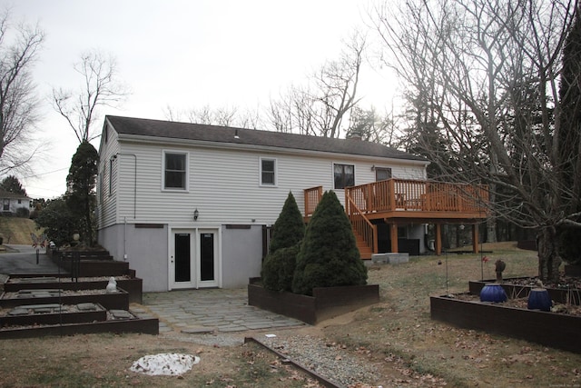 back of house featuring a deck, a patio area, and stairway