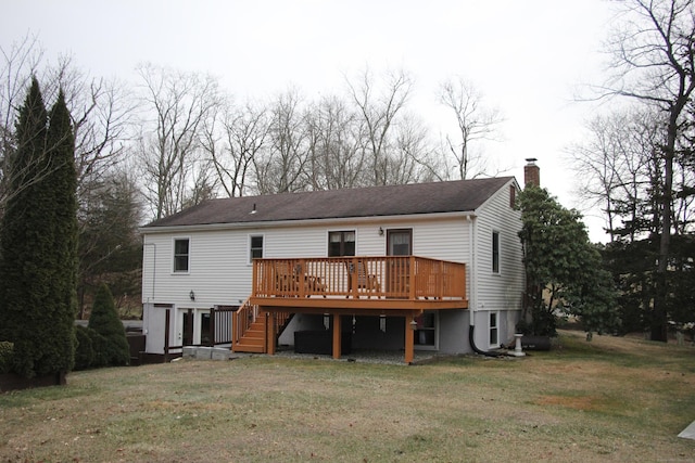 back of property featuring a chimney, stairway, a lawn, and a wooden deck