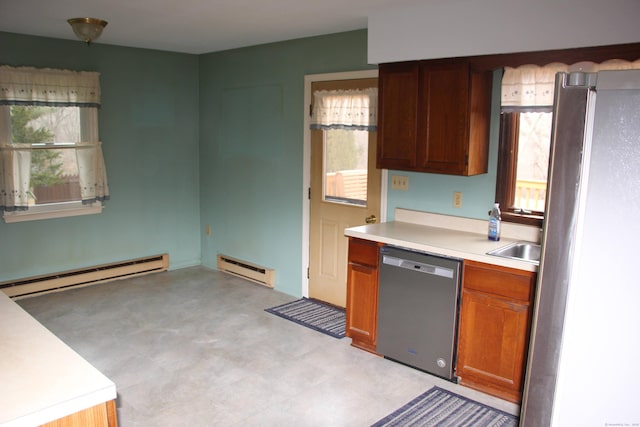 kitchen featuring light floors, a baseboard heating unit, stainless steel appliances, and light countertops