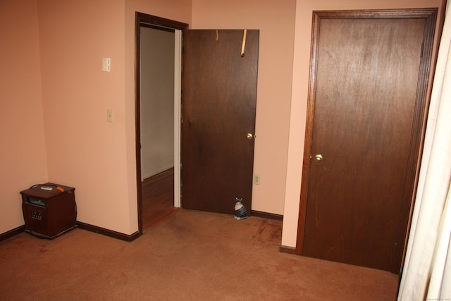 unfurnished bedroom featuring carpet floors and baseboards