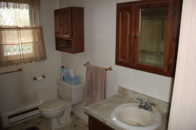 bathroom with a baseboard radiator, vanity, and toilet