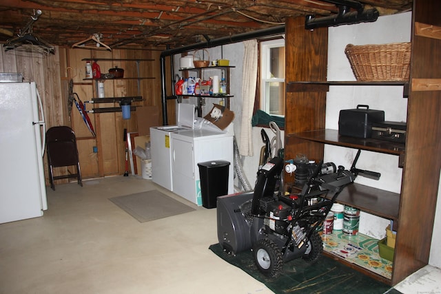 below grade area with washer and clothes dryer and freestanding refrigerator