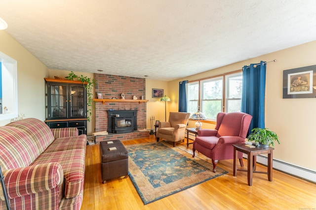 living room with a textured ceiling, a baseboard radiator, and wood finished floors