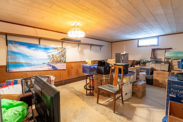 interior space with wooden ceiling, concrete floors, baseboard heating, and wainscoting