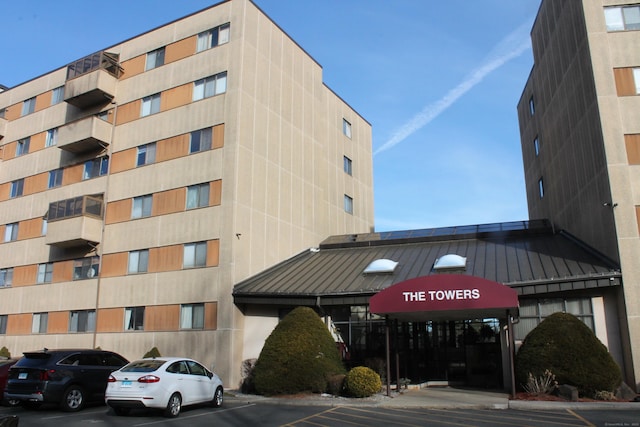 view of building exterior featuring uncovered parking