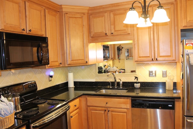 kitchen featuring black appliances, tasteful backsplash, hanging light fixtures, and a sink