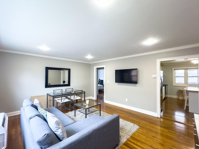 living room with crown molding, wood finished floors, and baseboards