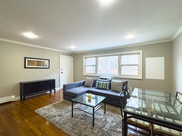 living room with a baseboard heating unit, baseboards, ornamental molding, and wood finished floors