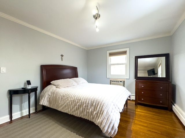 bedroom featuring crown molding, baseboards, and wood finished floors