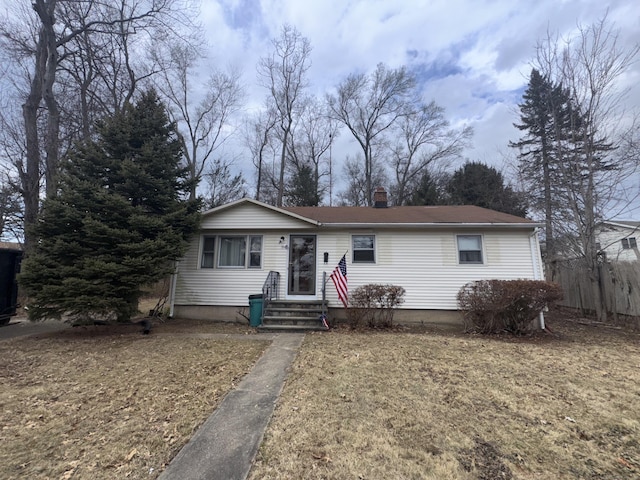 single story home featuring a chimney