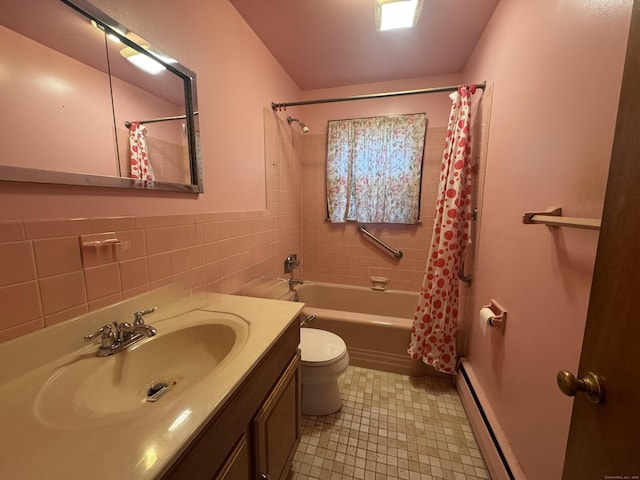 bathroom with toilet, shower / bath combination with curtain, vanity, a baseboard heating unit, and tile walls