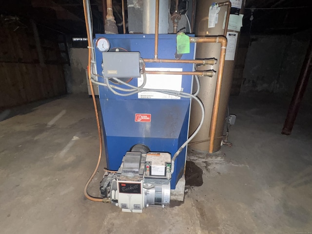 utility room with water heater and heating unit