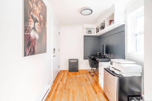 office space with light wood-style flooring, baseboards, and crown molding