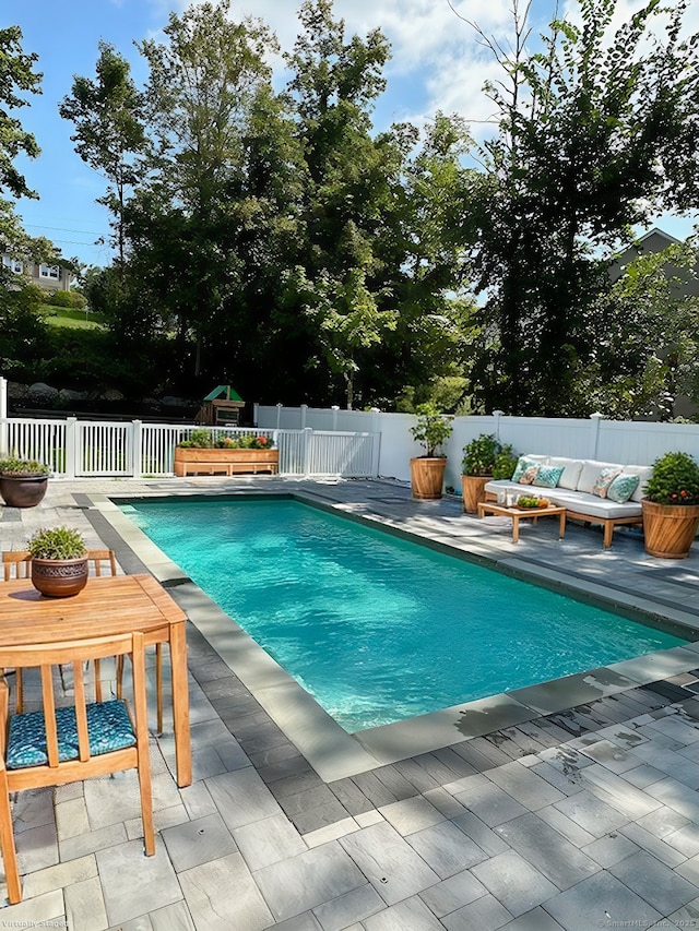 view of swimming pool with an outdoor hangout area, a patio area, a fenced backyard, and a fenced in pool