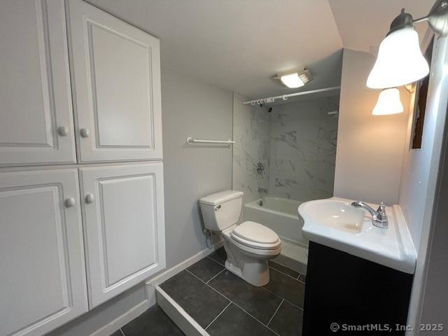 bathroom featuring baseboards, toilet, shower / tub combination, tile patterned floors, and vanity