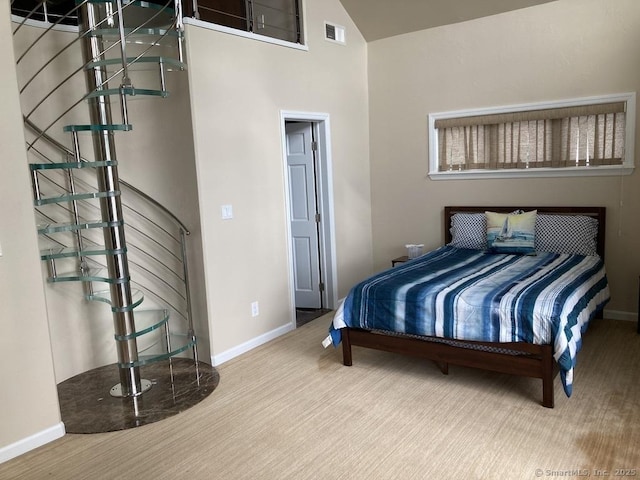 bedroom with visible vents, vaulted ceiling, and baseboards