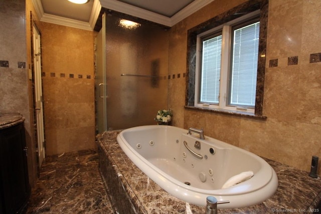 full bath featuring a jetted tub, marble finish floor, crown molding, a walk in shower, and tile walls