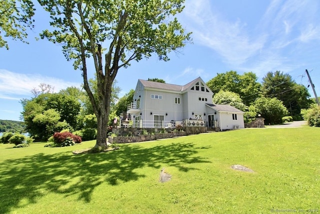 rear view of property with a lawn