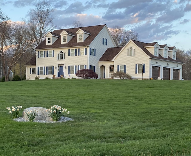 view of front facade featuring a garage and a front lawn