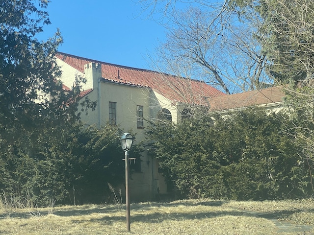 view of home's exterior featuring a tiled roof and stucco siding