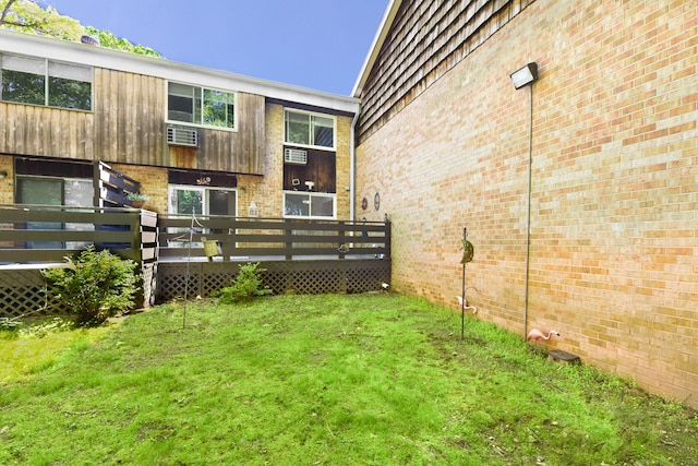 view of grassy yard featuring a wooden deck