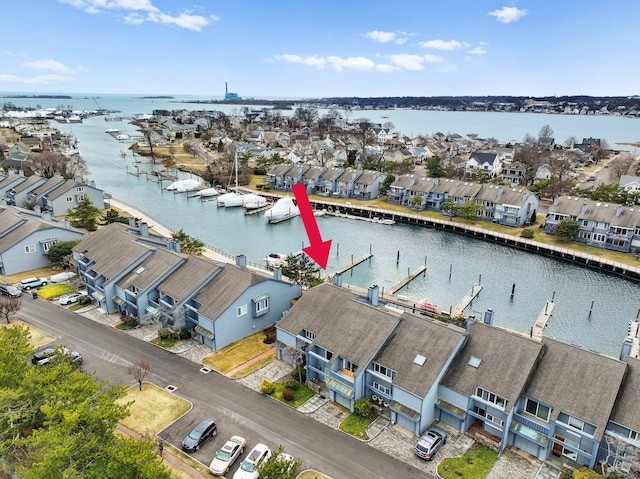 drone / aerial view featuring a residential view and a water view