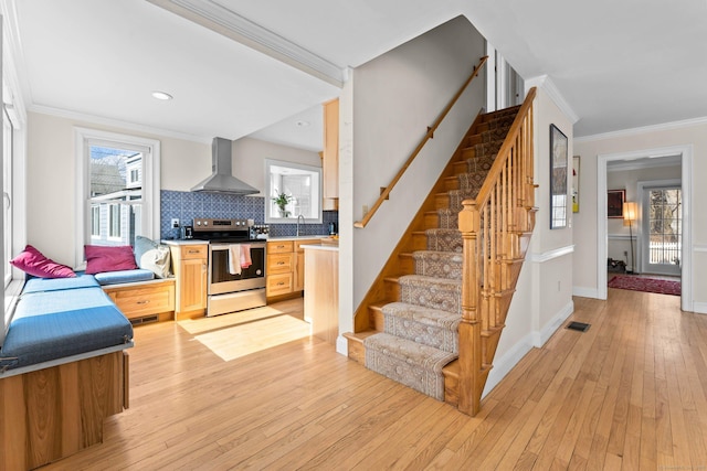 interior space with plenty of natural light, crown molding, and hardwood / wood-style flooring