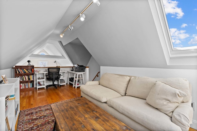 living area with lofted ceiling and wood finished floors