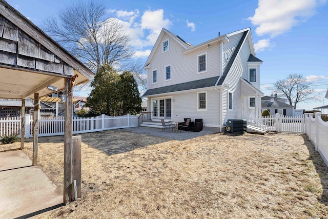 back of property with a shingled roof, entry steps, cooling unit, a fenced backyard, and a patio