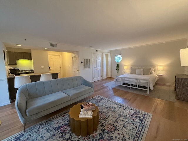 interior space with baseboards, visible vents, and light wood-style floors