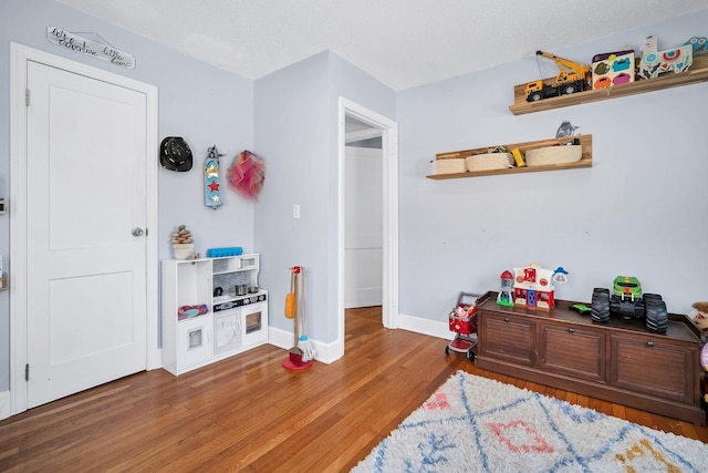 bedroom featuring baseboards and wood finished floors