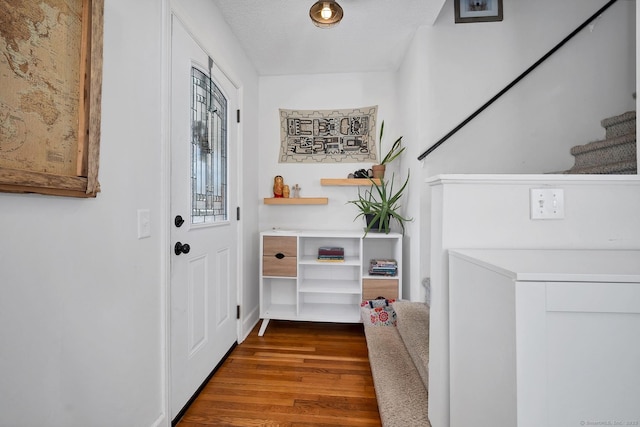 doorway to outside with stairway and wood finished floors