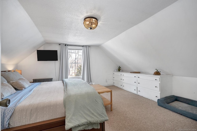 bedroom featuring light carpet, vaulted ceiling, a textured ceiling, and radiator heating unit