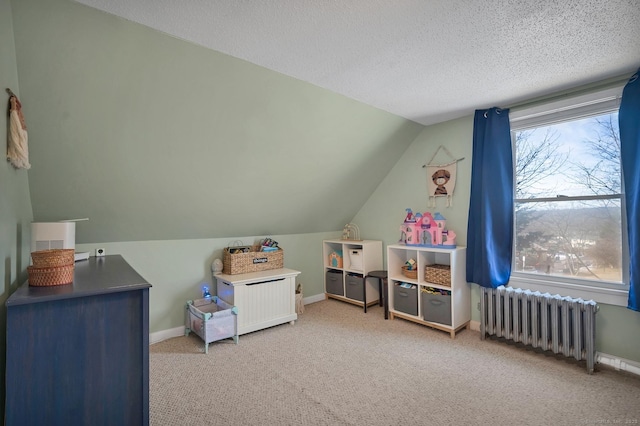 game room with carpet, lofted ceiling, radiator, a textured ceiling, and baseboards