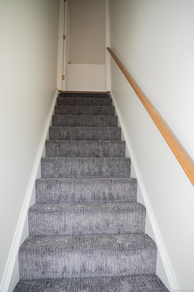 stairway featuring baseboards