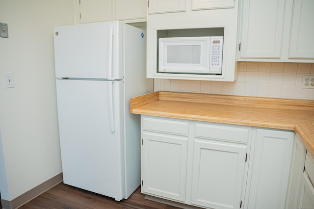 kitchen with white appliances, white cabinetry, light countertops, decorative backsplash, and dark wood-style floors