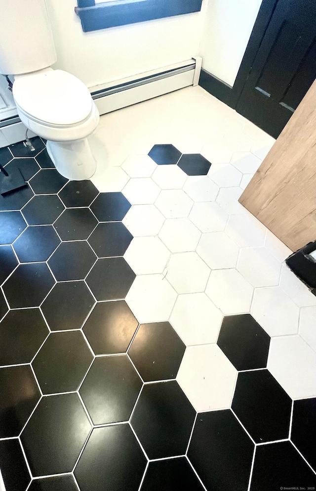 bathroom featuring toilet and a baseboard radiator