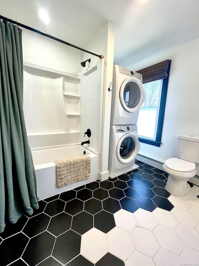 full bath with toilet, baseboard heating, tile patterned floors, stacked washer / drying machine, and shower / bathtub combination with curtain