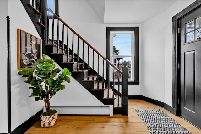 entryway with plenty of natural light, wood finished floors, and baseboards