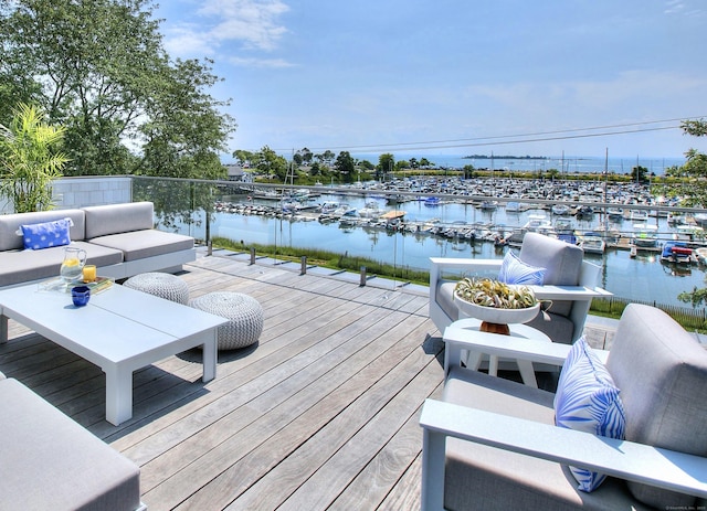 deck with a water view and outdoor lounge area