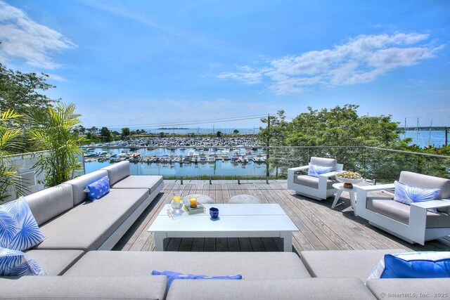 wooden terrace with outdoor lounge area and a water view