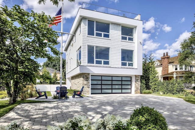 view of front of house featuring a patio and an attached garage